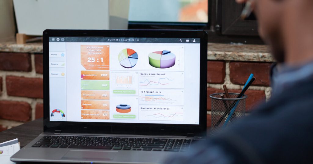 Analytics dashboard on a laptop showing conversion charts and revenue metrics from A/B testing