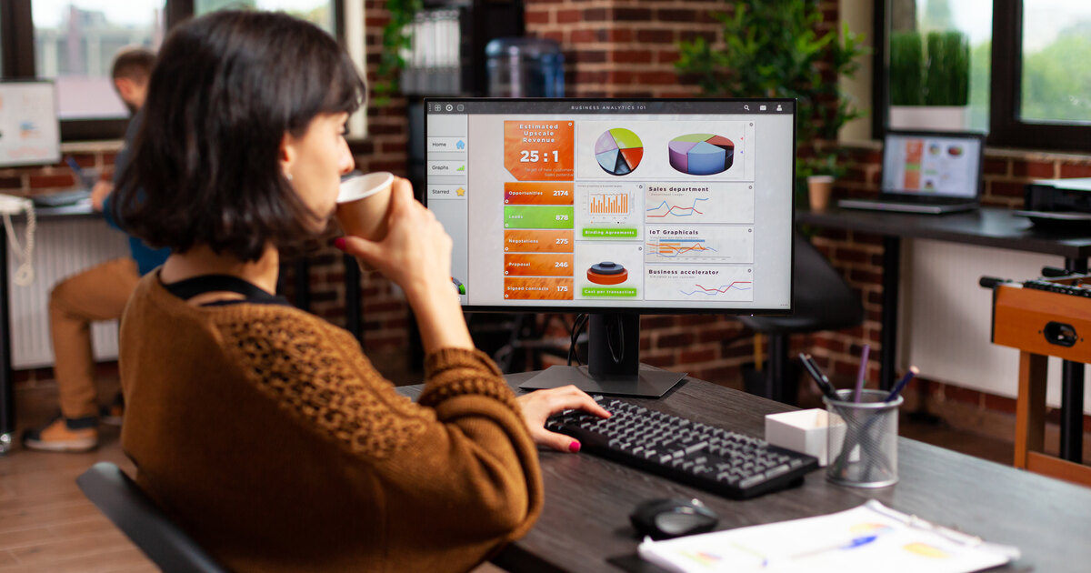 Marketer reviewing a business analytics dashboard while setting up tracking