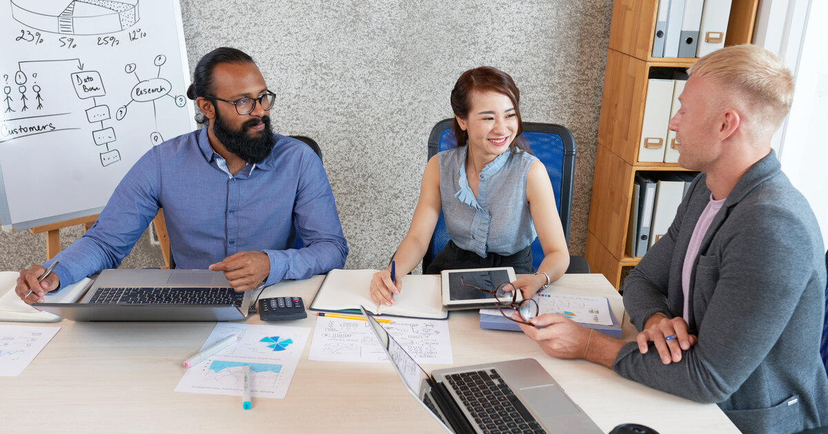 Marketing team discussing a sales pipeline funnel and reports at a conference table