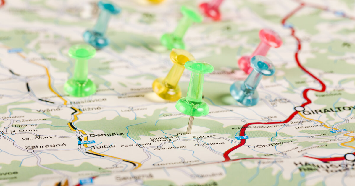Colored pushpins marking separate regions on a map, illustrating matched test and control geos in a geo holdout